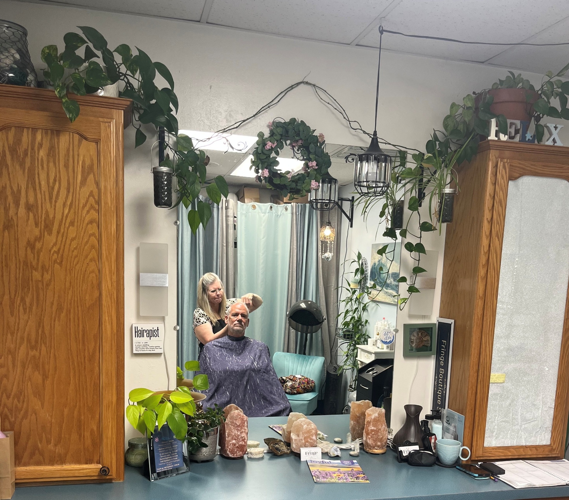 Jeanette cutting a client's hair in the salon